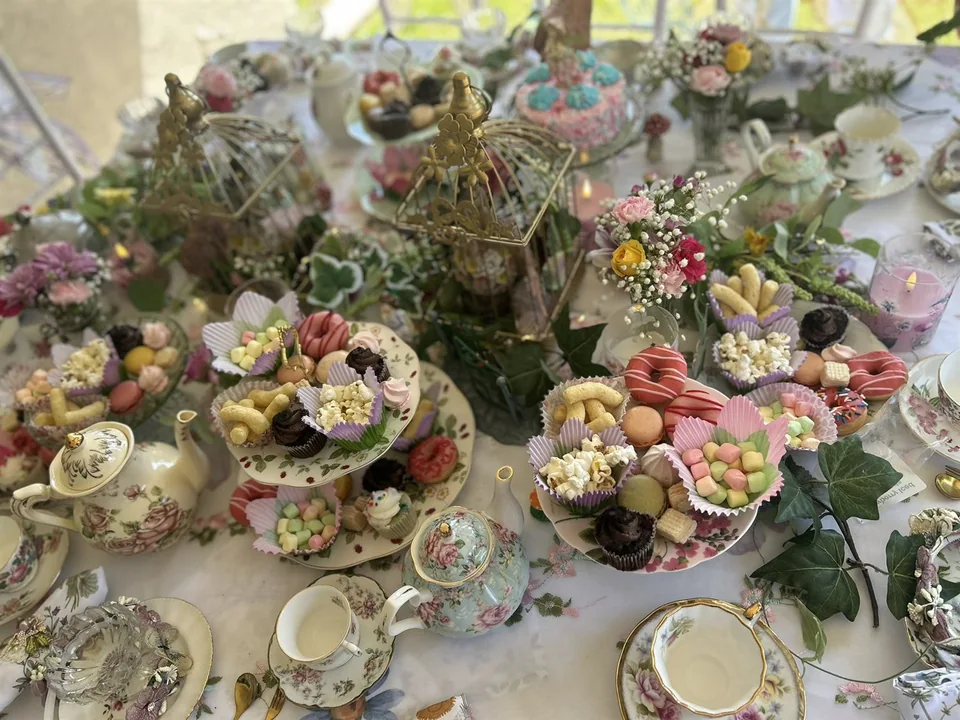 Tiered sweets, flowers, teapots, and fine china