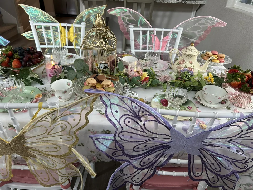 Fairy tea party table with pastel wings on the chairs