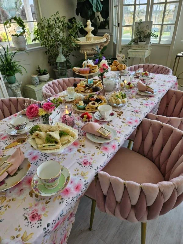 A traditional tea party with fine china and floral table decorations