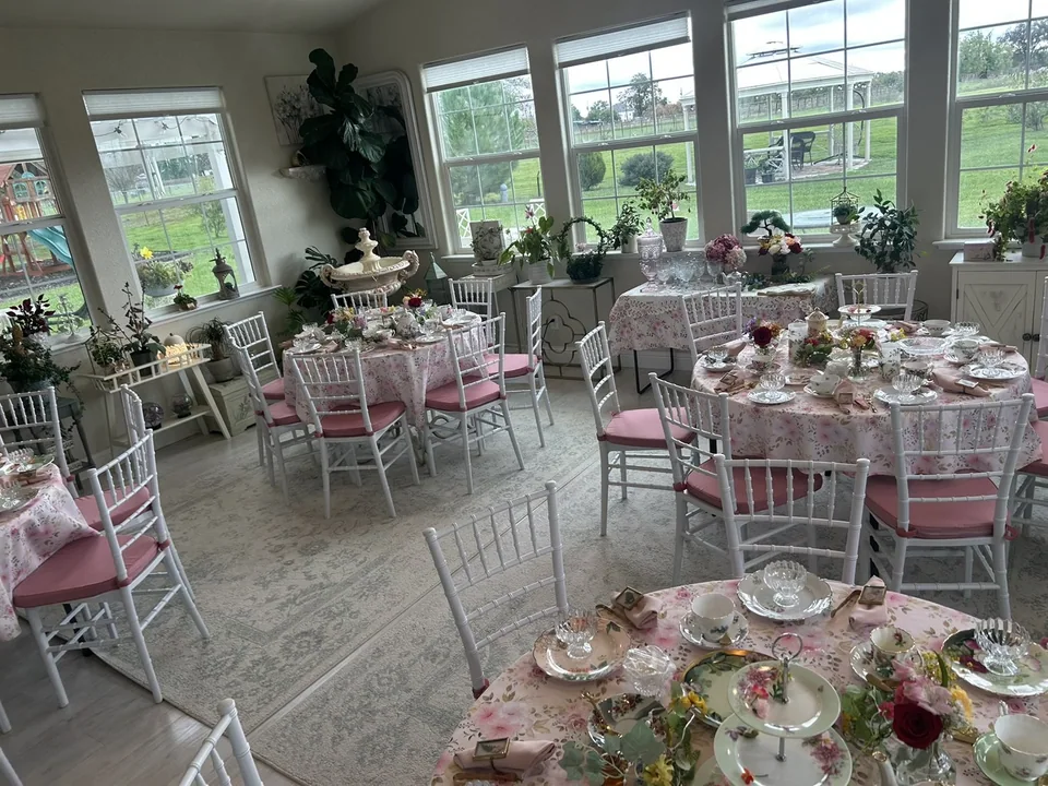 A room with several decorated tea-party tables