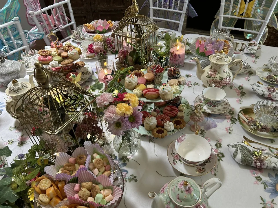 Desserts, candles, flowers, and teacups